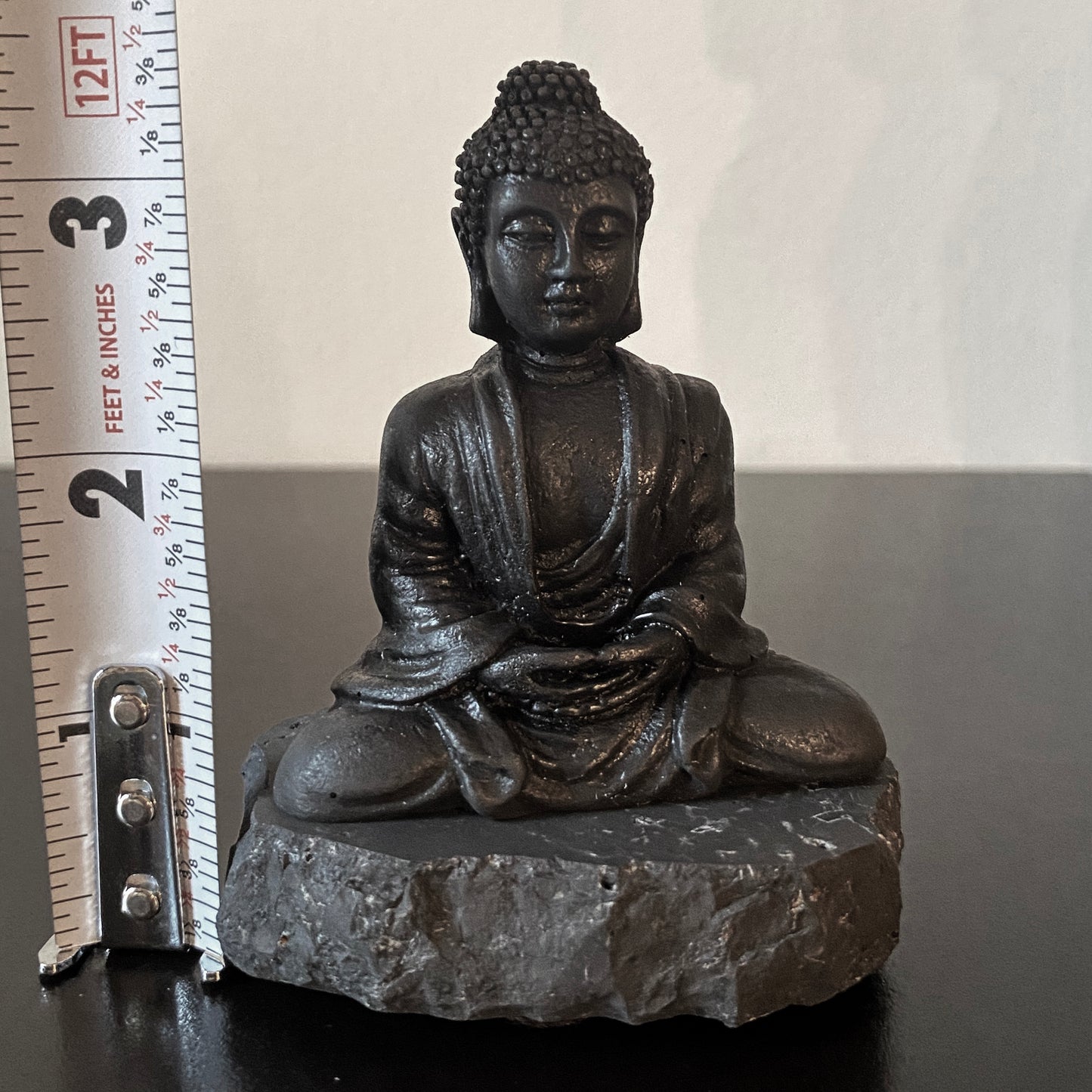 Shungite Buddha figurine on Rock